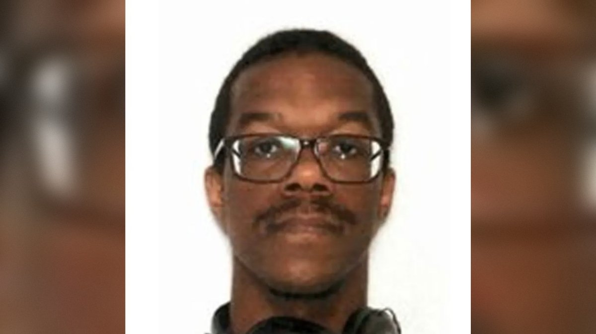 Portrait of a young man with glasses and headphones, looking directly at the camera against a plain background.