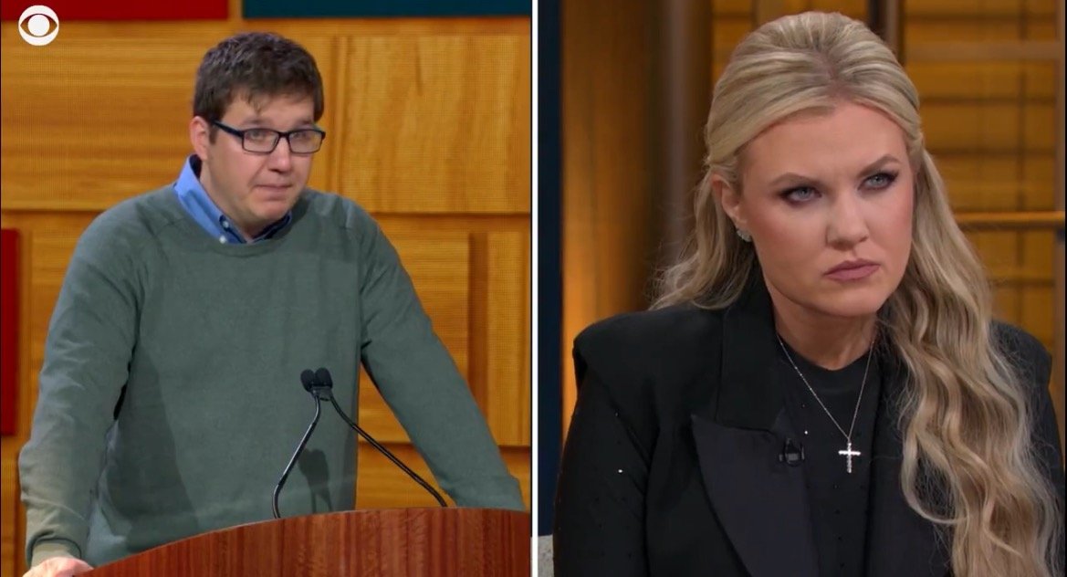 A man in a green sweater speaks at a podium while a woman in a black blazer listens intently during a discussion.
