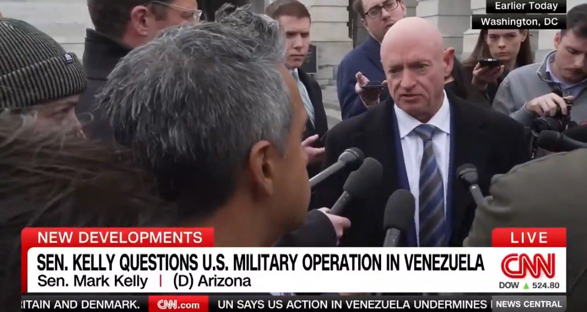 Senator Mark Kelly addresses reporters in Washington, D.C., discussing U.S. military operations in Venezuela amidst a gathering of journalists.