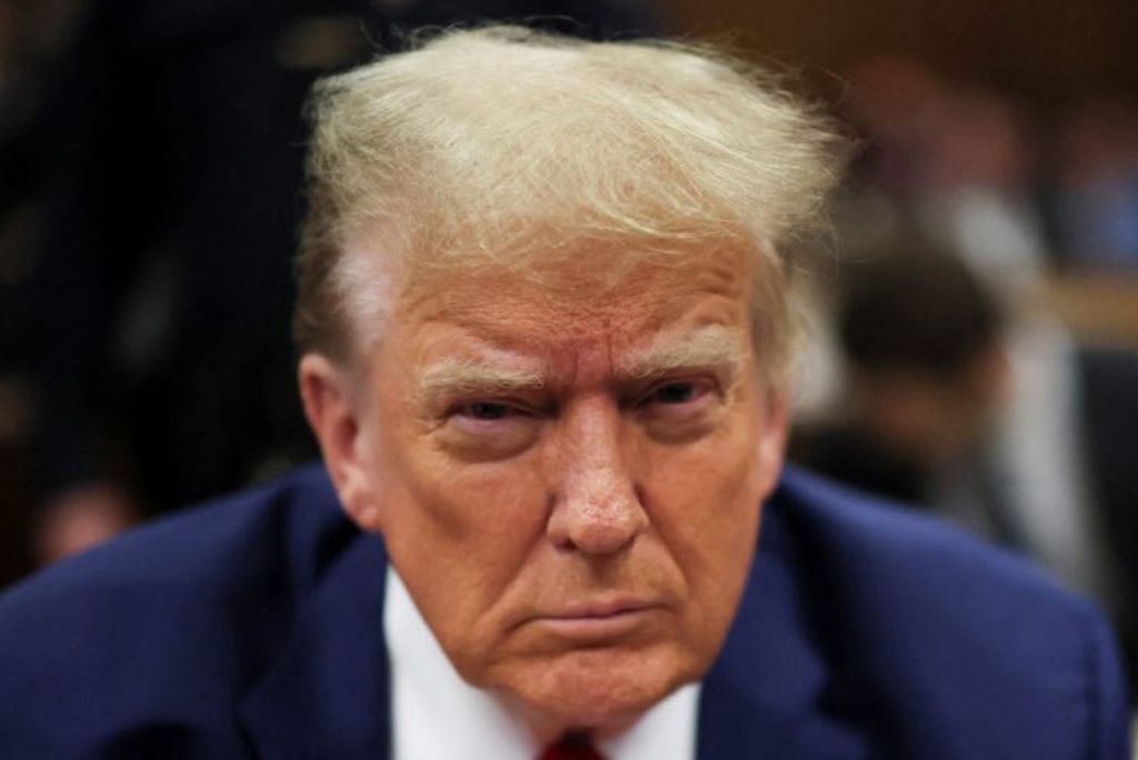 Serious expression of a man in a suit during a formal event, highlighting intense focus and engagement.