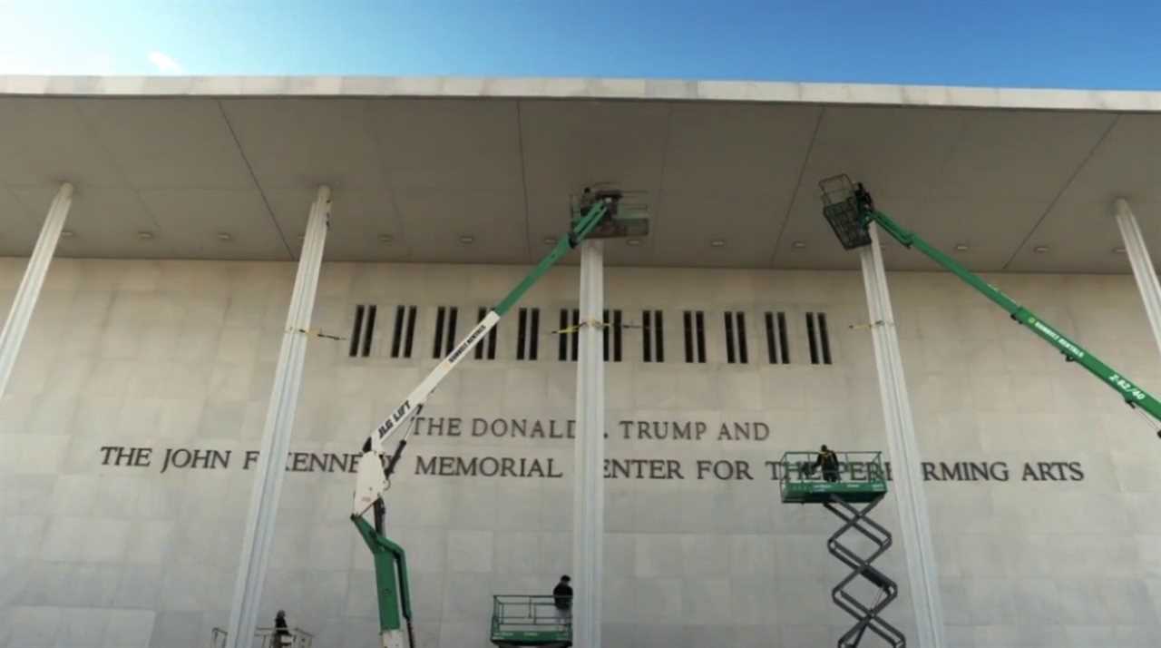 Workers using lifts to perform maintenance on the exterior of the John F. Kennedy Center for the Performing Arts in Washington, D.C.